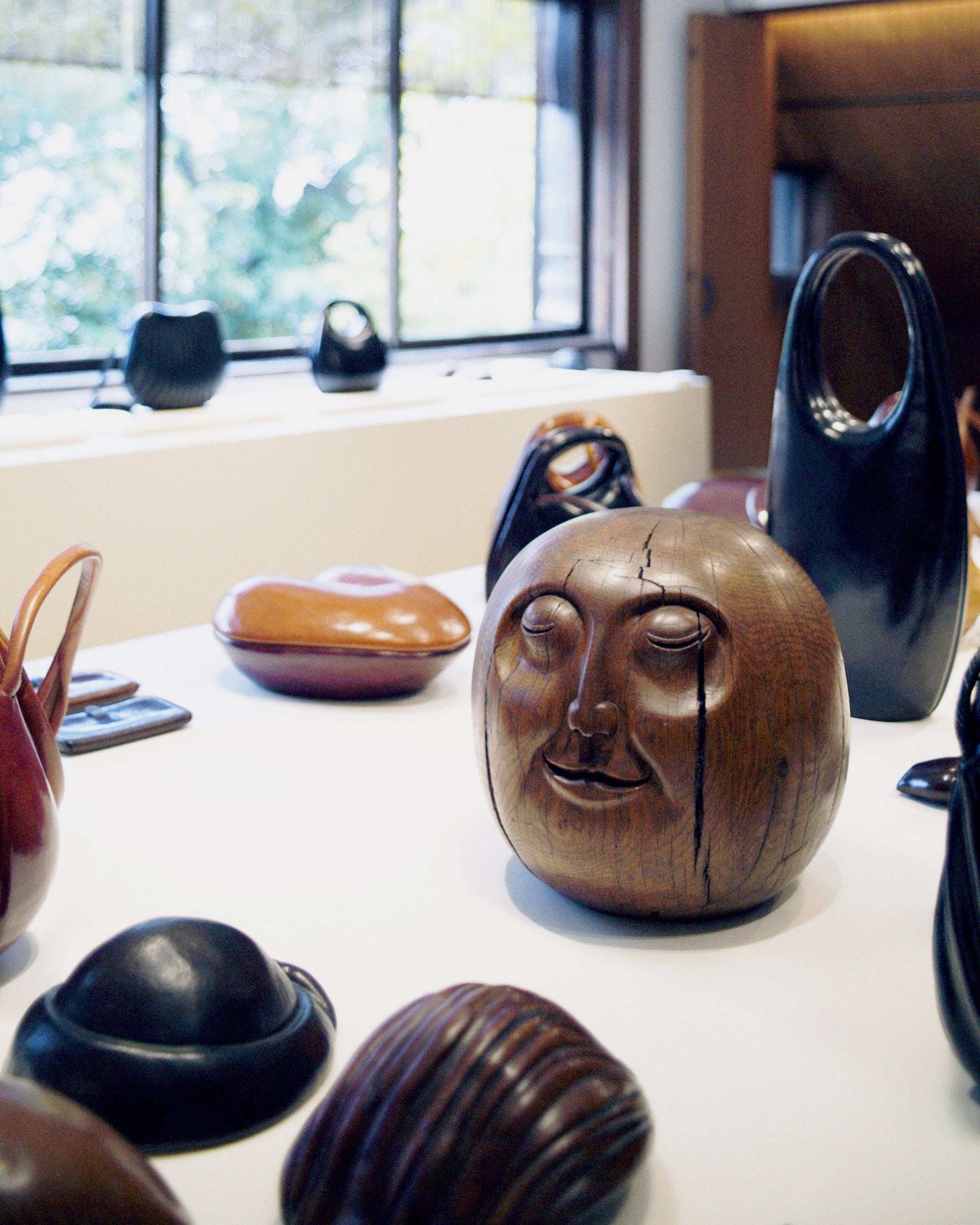 Wooden sculptures in Brown and black wood, Front view Carved with faces