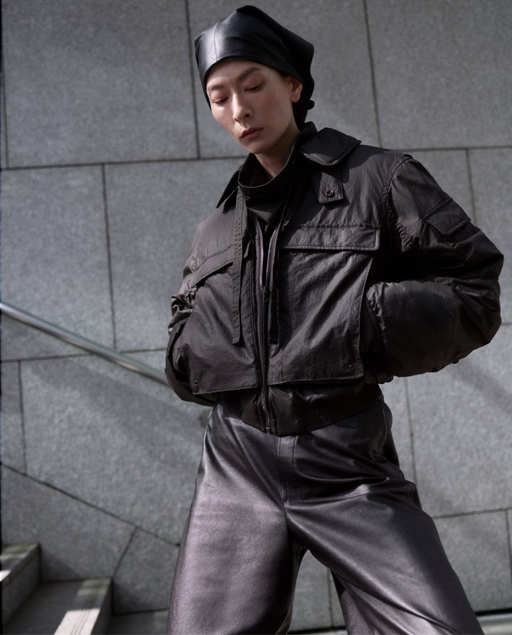 Black jacket and pants in black nylon and leather, model shot, front view oversized