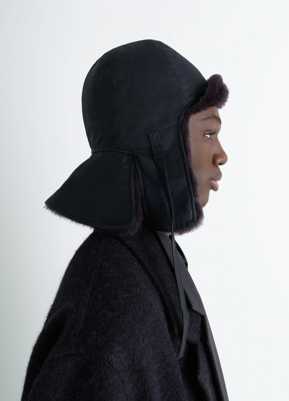 Lemaire Reversible Shearling Chapka in Black Water-Repellent Cotton, model shot, Side view Inspired by aviator hats