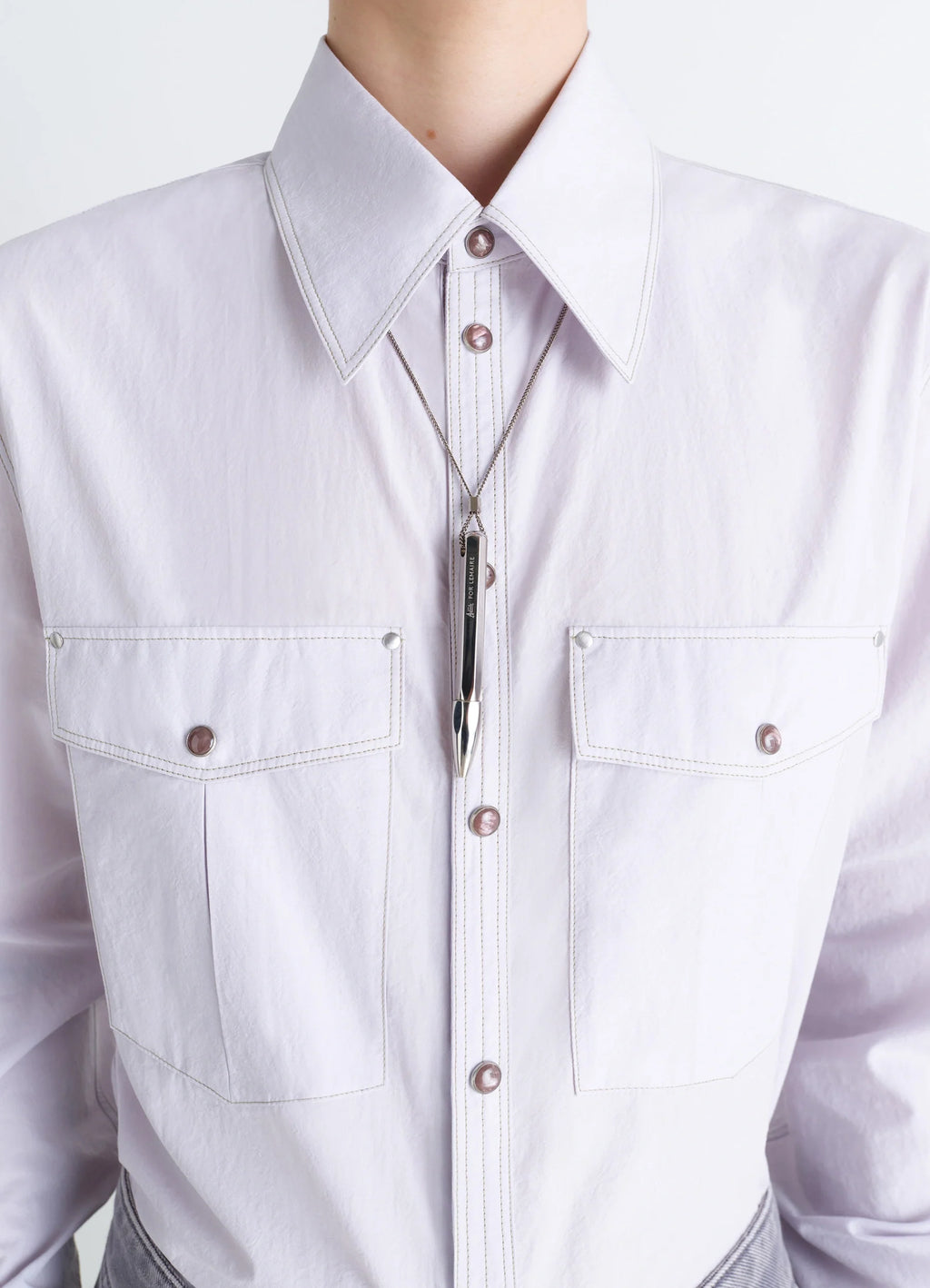 Aubock pen necklace in silver metal, model shot, detail shot worn over shirt