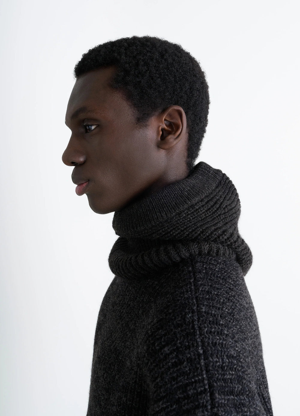 HOOD Ribbed Wool and Alpaca Blend in Dark Charcoal Wool Alpaca, model shot, Side view Ribbed knit texture