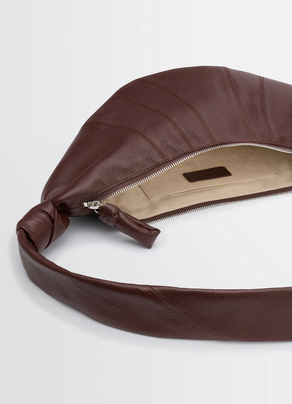 Lemaire medium croissant bag in grained leather, product shot, top detail shot zipper opening, knotted strap