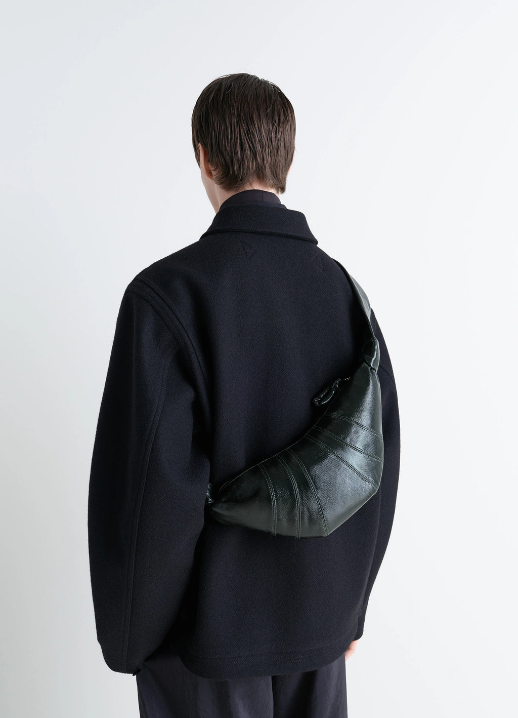Lemaire small croissant bag in coated cotton canvas, model shot, back view worn on shoulder