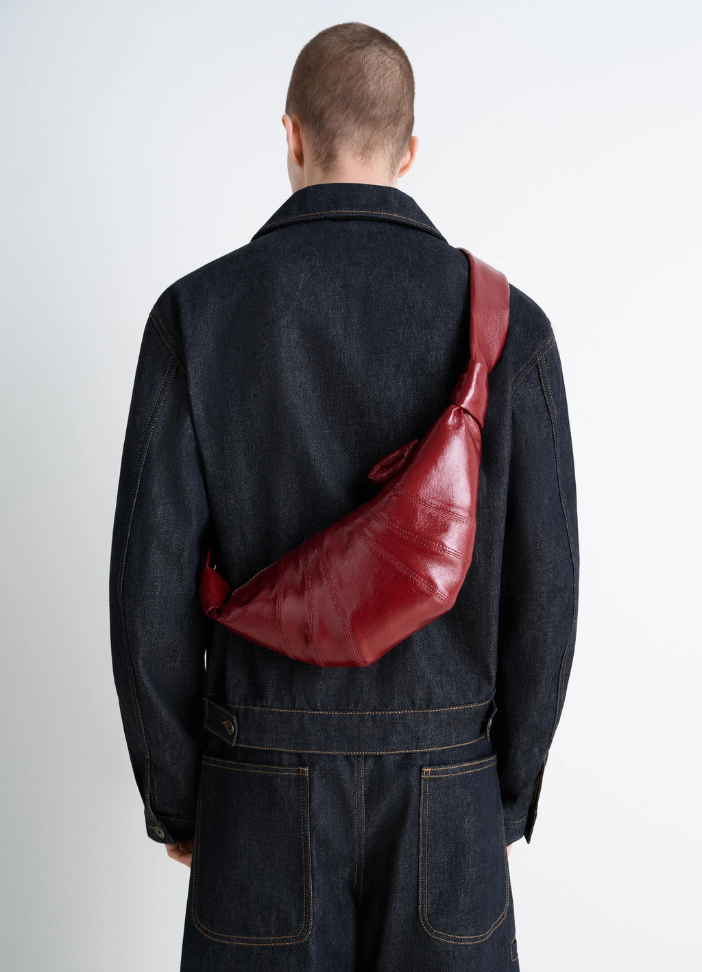 Lemaire small croissant bag in coated cotton canvas, model shot, back view textured shiny look
