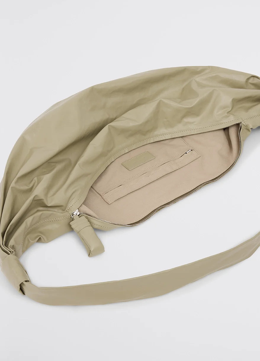 Medium soft croissant bag in lightweight shiny leather, product shot, interior view zippered pocket