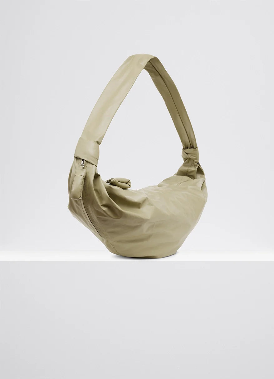 Medium soft croissant bag in lightweight shiny leather, product shot, back angle exposed zip closure