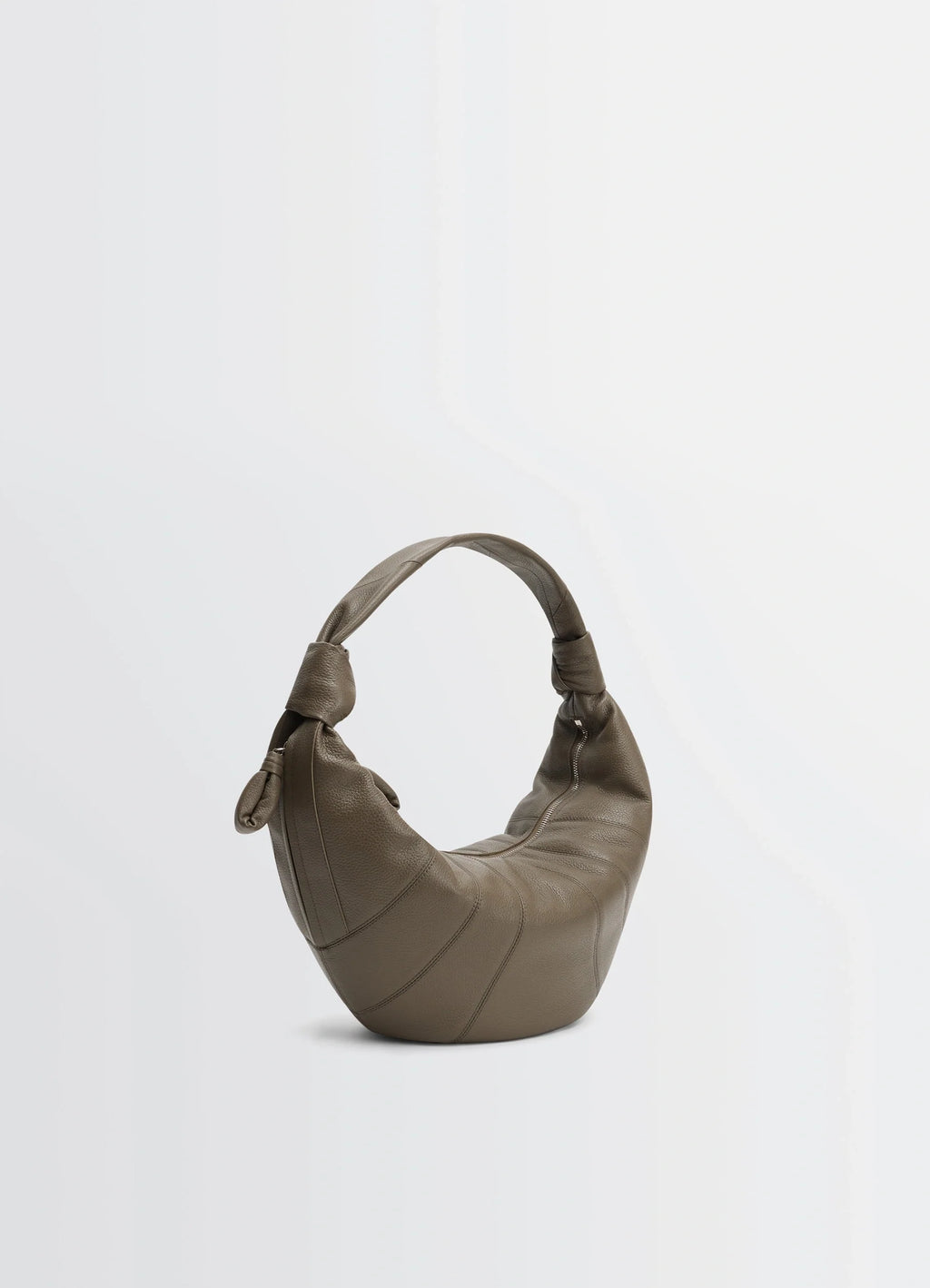 Fortune croissant bag in grained leather, product shot, angled back view double-knotted handle