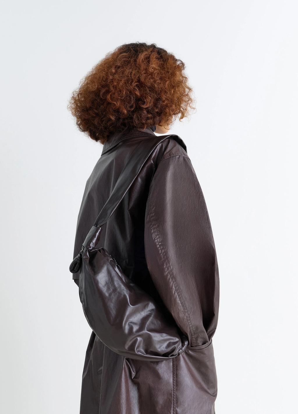 Small soft croissant bag in paper-effect leather, model shot, back view knotted elements