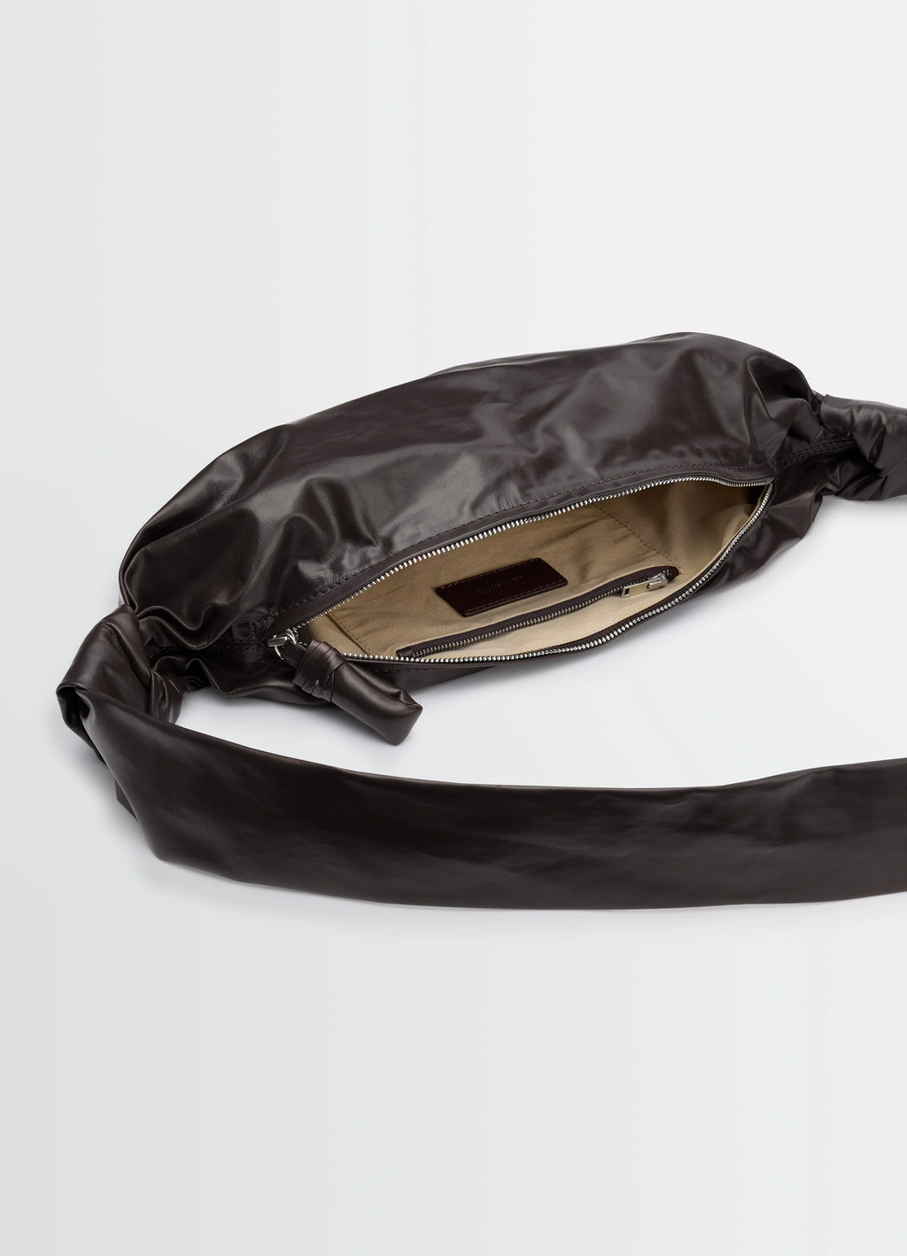 Small soft croissant bag in paper-effect leather, product shot, interior view zippered opening