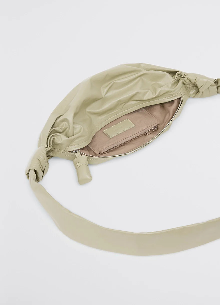 Small soft croissant in lightweight shiny leather, product shot, interior view open zipper with lining