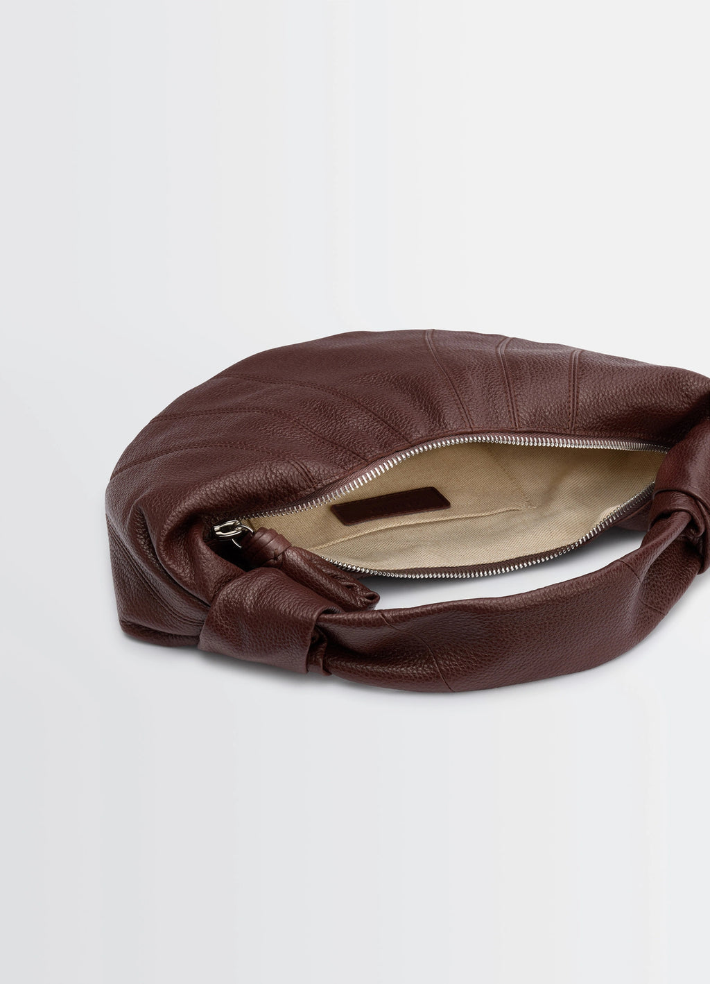 Mini fortune croissant bag in brown grained leather, product shot, top view open zipper and interior