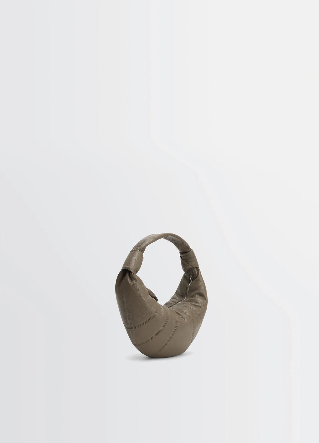 Mini fortune croissant bag in grained leather, product shot, angled view knotted handle