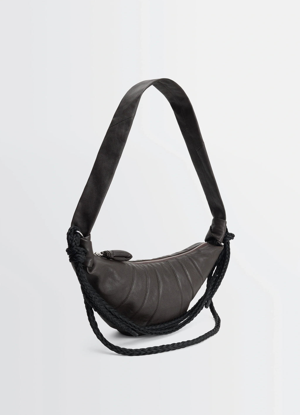 Lemaire braid medium croissant bag in grained buffalo leather, product shot, angled view curved shape with zip closure