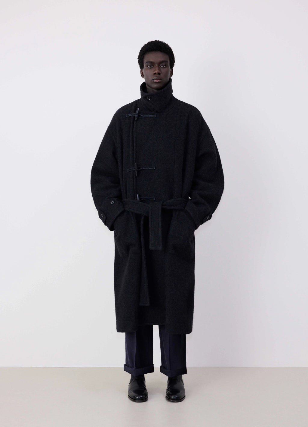 Lemaire oversized short duffle coat in dark wool and alpaca mix, model shot, front view belted oversized fit