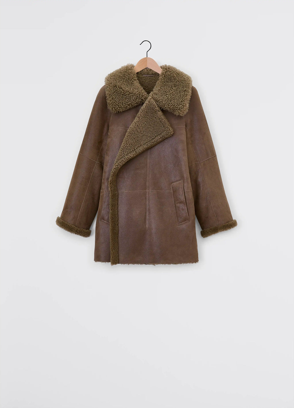Lemaire asymmetrical shearling coat in curly lamb shearling, grained leath, product shot, detail shot trench style pockets