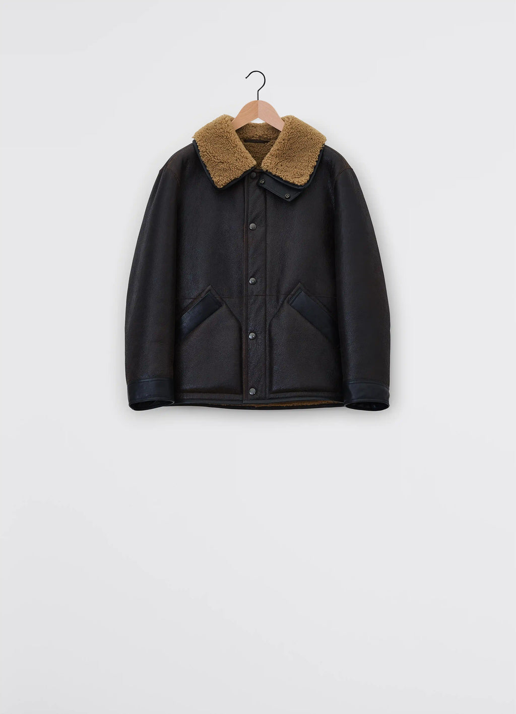 Lemaire shearling coat in heavy lamb shearling, product shot, hanger upper view exposed shearling collar