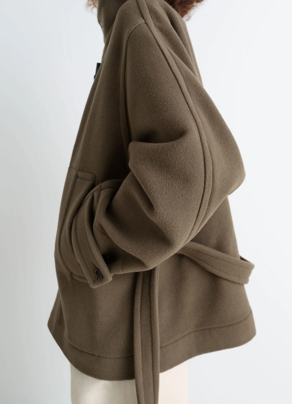 Lemaire short duffle coat in olive double-faced wool, model shot, close-up side detail dropped shoulder, relaxed fit