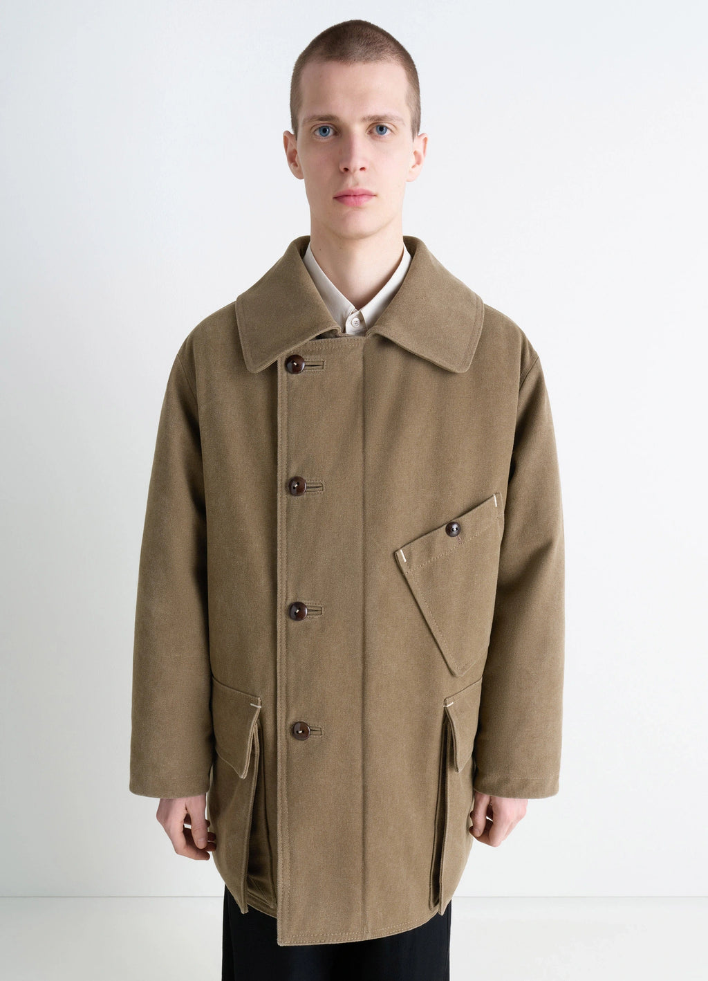 Shearling winter parka in brown cotton canvas, model shot, half-body view asymmetrical pocket detail