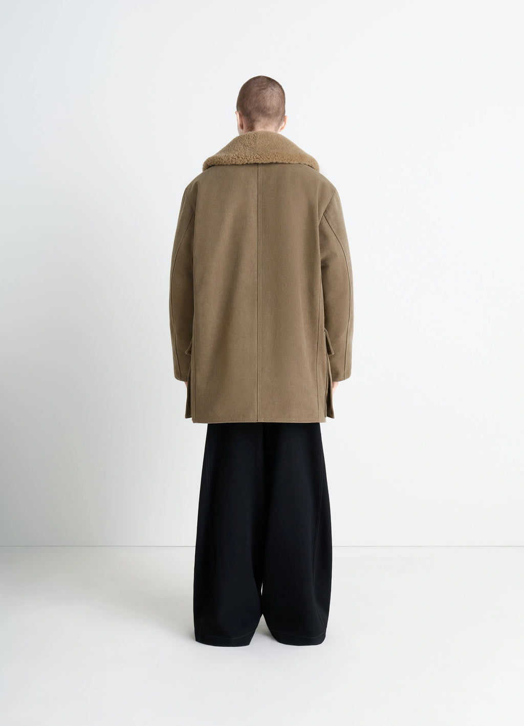 Shearling winter parka in brown cotton canvas, model shot, back view relaxed fit silhouette
