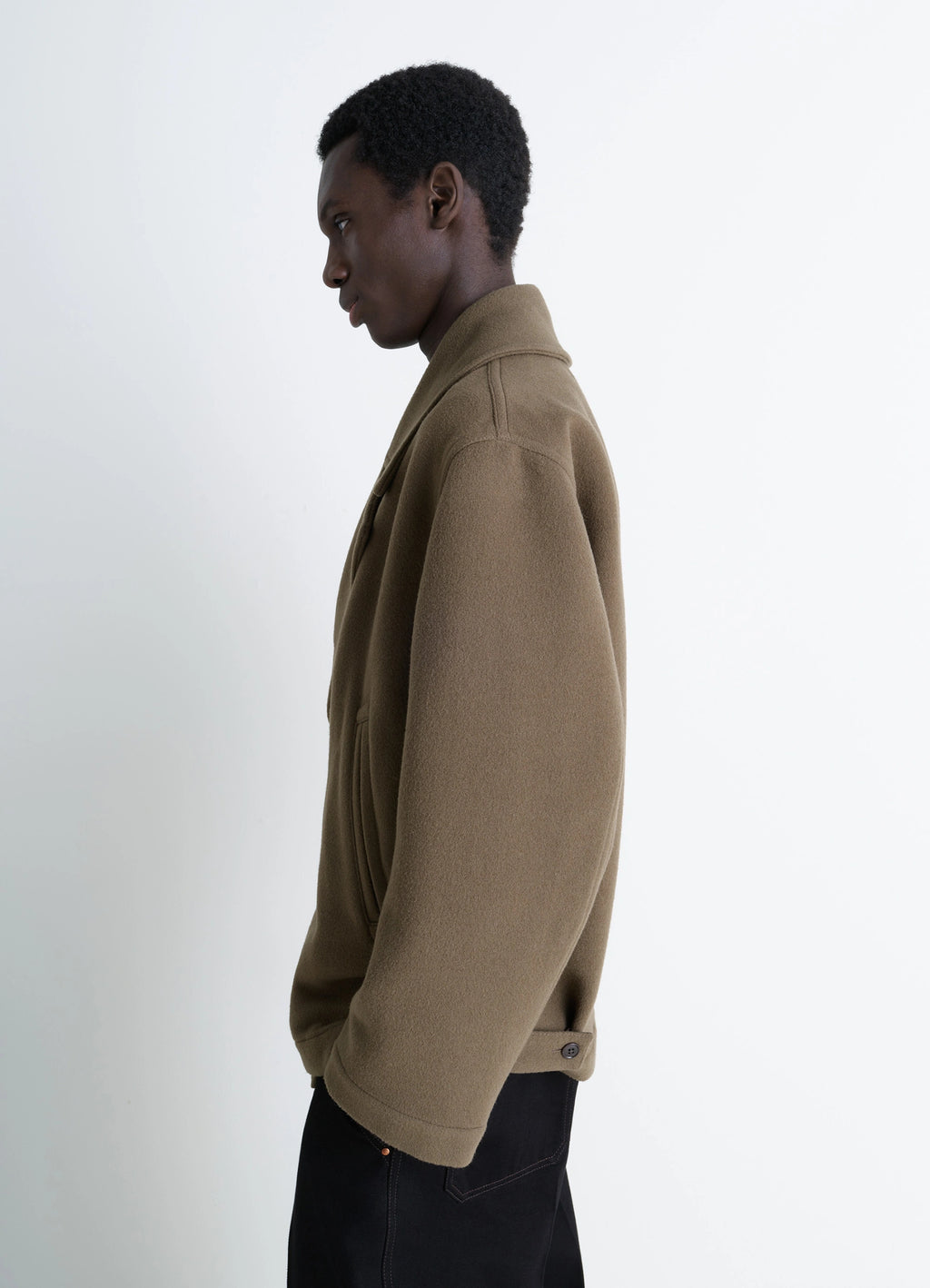 Lemaire boxy peacoat in double-faced wool, model shot, side view buttoned cuffs