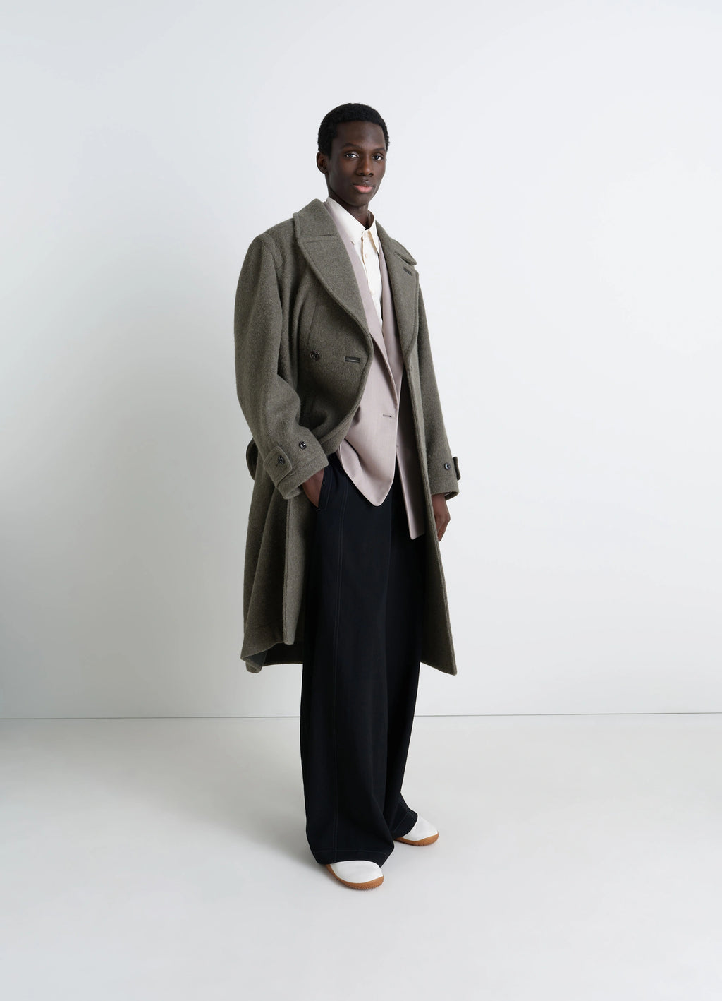 Lemaire soft coat in wool and alpaca blend, model shot, front three-quarter view loose fit, herringbone trim