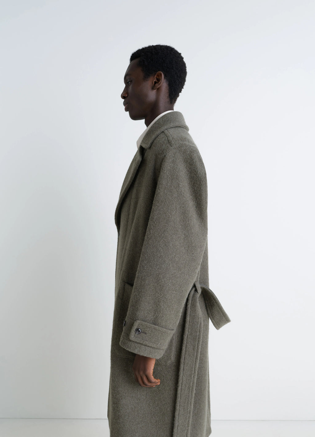 Lemaire soft coat in wool and alpaca blend, model shot, side profile view buttoned cuff detail