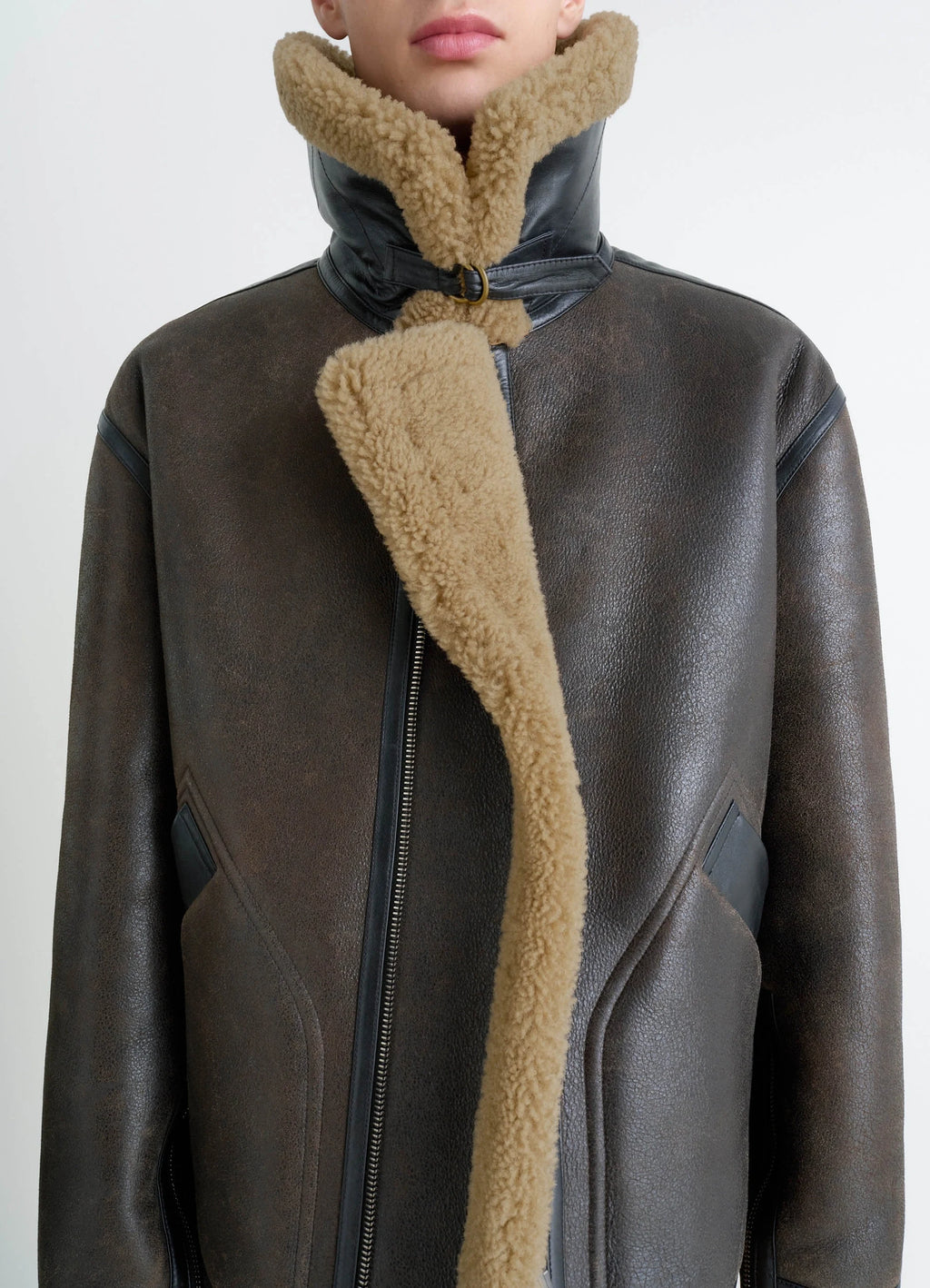 Shearling coat in contrasting leather trim, model shot, close-up front detail raised collar open view