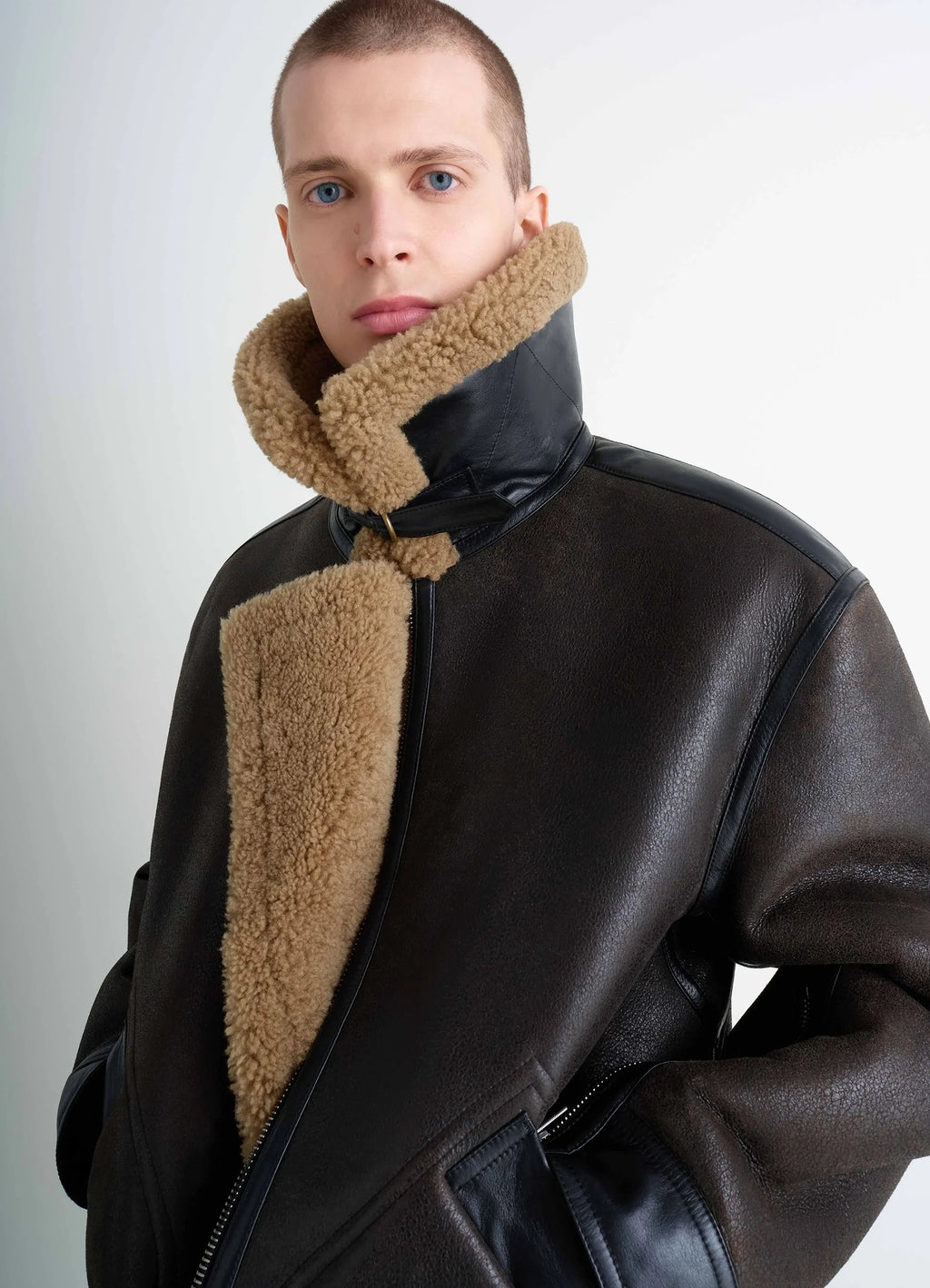 Shearling coat in contrasting leather trim, model shot, side profile raised collar