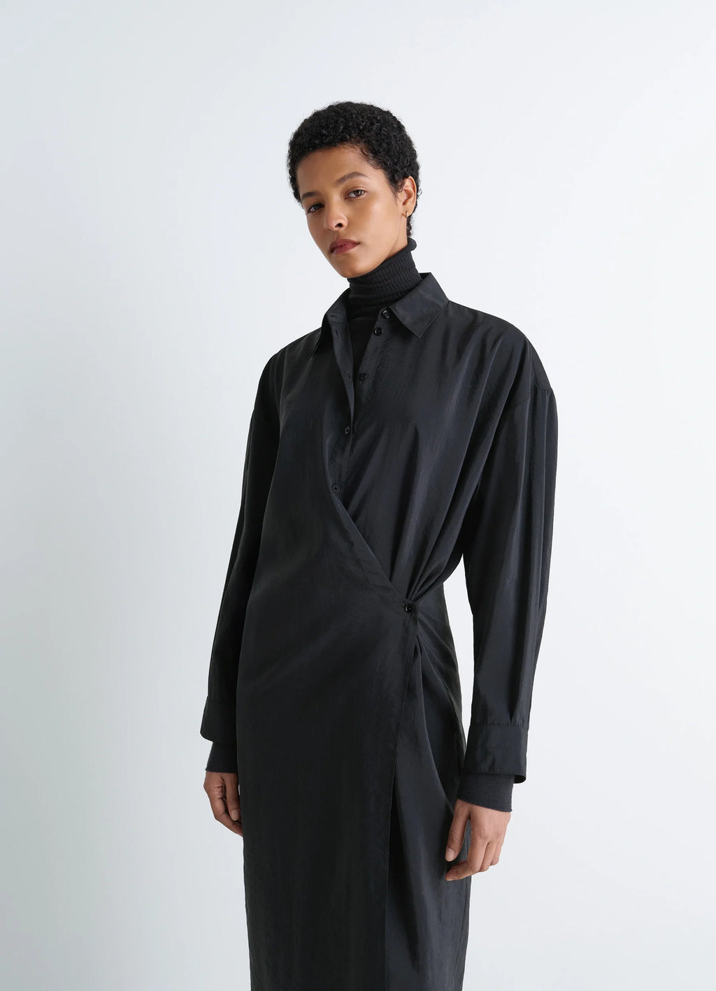 Lemaire straight collar twisted dre in black dry silk blend, model shot, three-quarter view draped front crossover