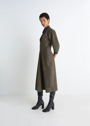 Lemaire leather v-neck dress in nubuck leather, model shot, side view fitted with midi length