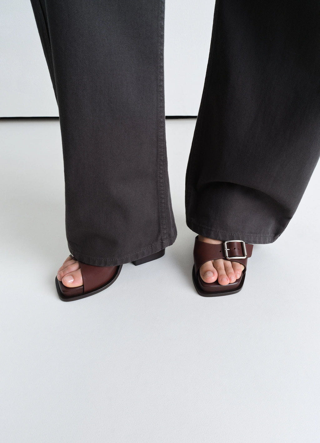 Lemaire square heeled sandals in smooth vegetable-tanned leather, model shot, top-down view ankle strap with buckle