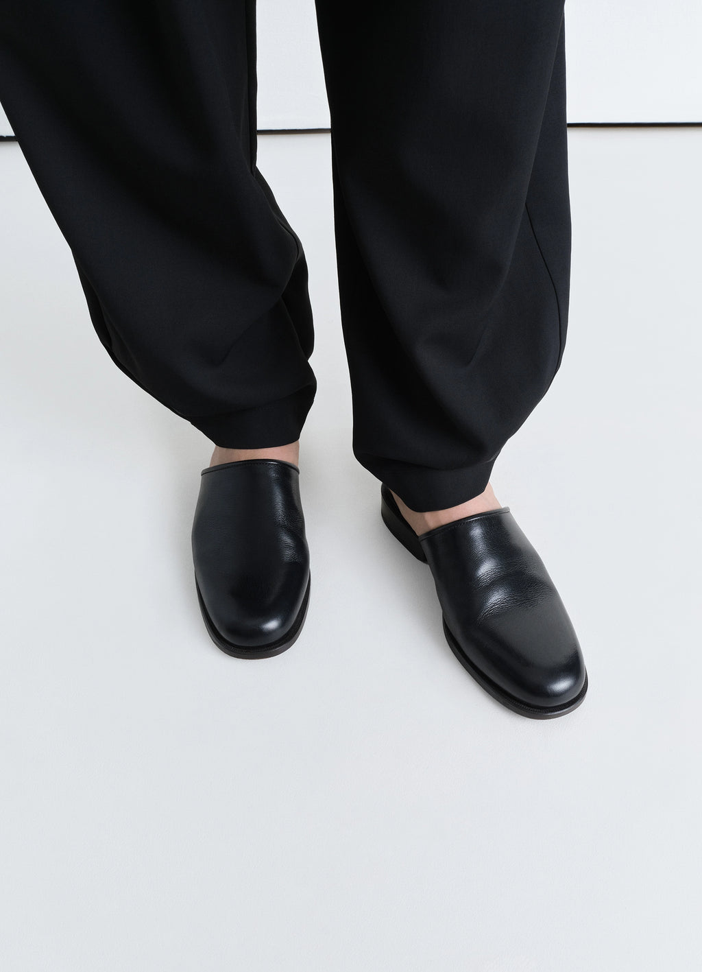 Lemaire square mule in shiny buffalo leather, model shot, top view worn with loose pants