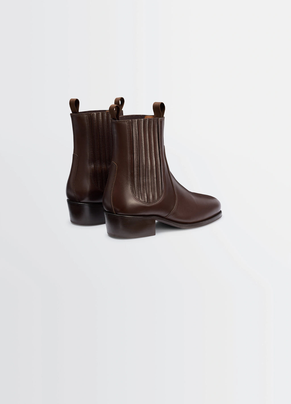 Chelsea boots in vegetable-tanned leather, product shot, back angle view pull tabs visible