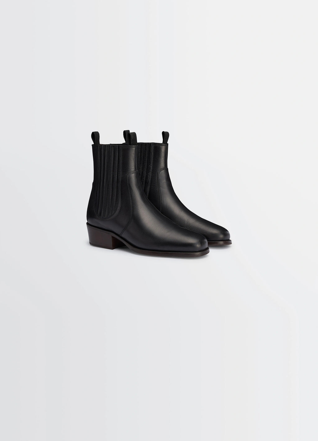 Chelsea ankle boots in black vegetable-tanned leather, product shot, angled front view square toe design