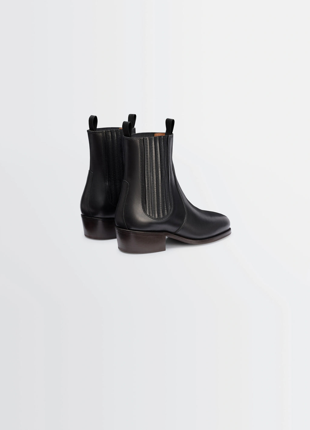 Chelsea ankle boots in black vegetable-tanned leather, product shot, back view pull tab design