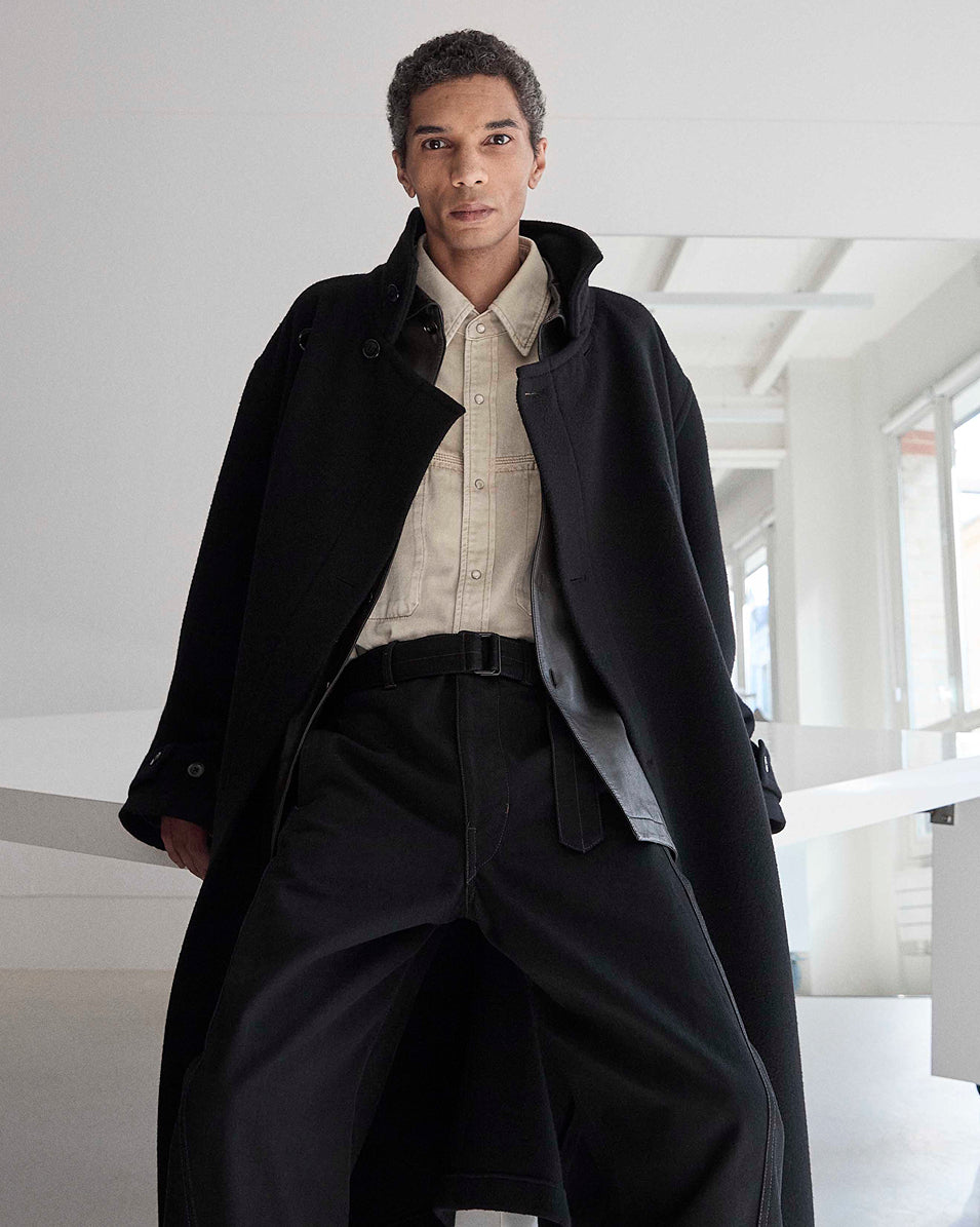 Black coat in black fabric, model shot, front view oversized