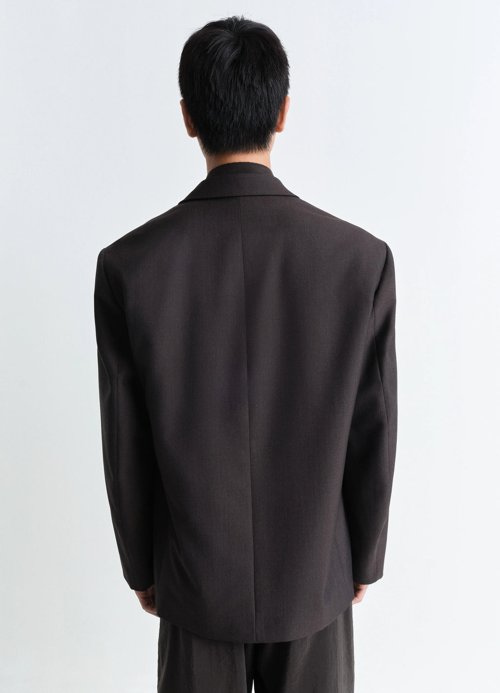 Lemaire soft double breasted jacket in tropical poly-wool mélange twill, model shot, back view ventless design