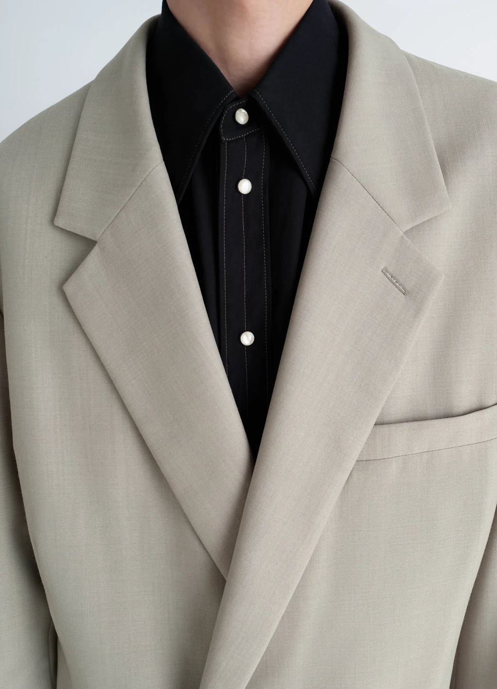 Soft double breasted jacket in mottled tropical wool-blend, model shot, close-up detail shot notched lapel