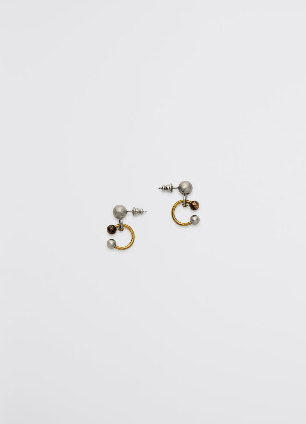 Lemaire rattle earrings in silver, copper, gold brass, product shot, top down view sculpted with shiny finish