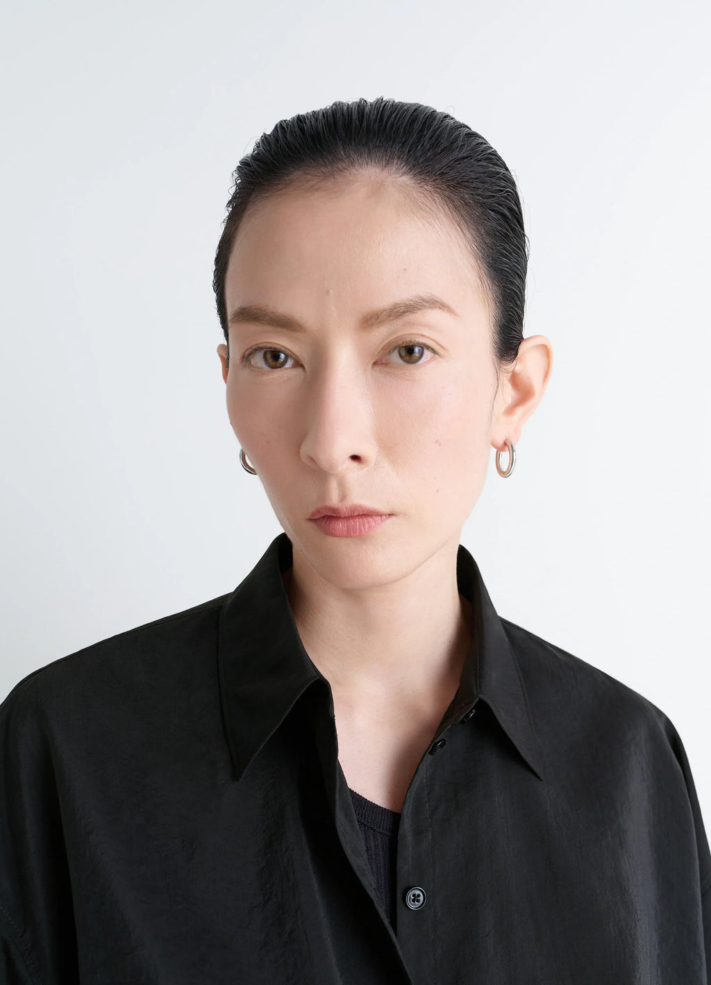 Lemaire classic hoops s in recycled rhodium-plated silver, model shot, side view elegant minimalist