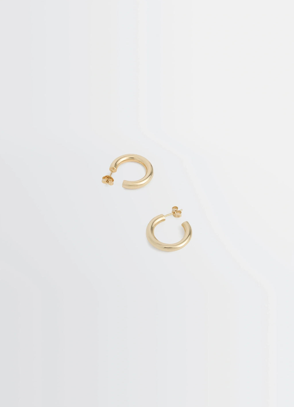 Classic hoops s in recycled gold-plated silver, product shot, top angled view minimalist design