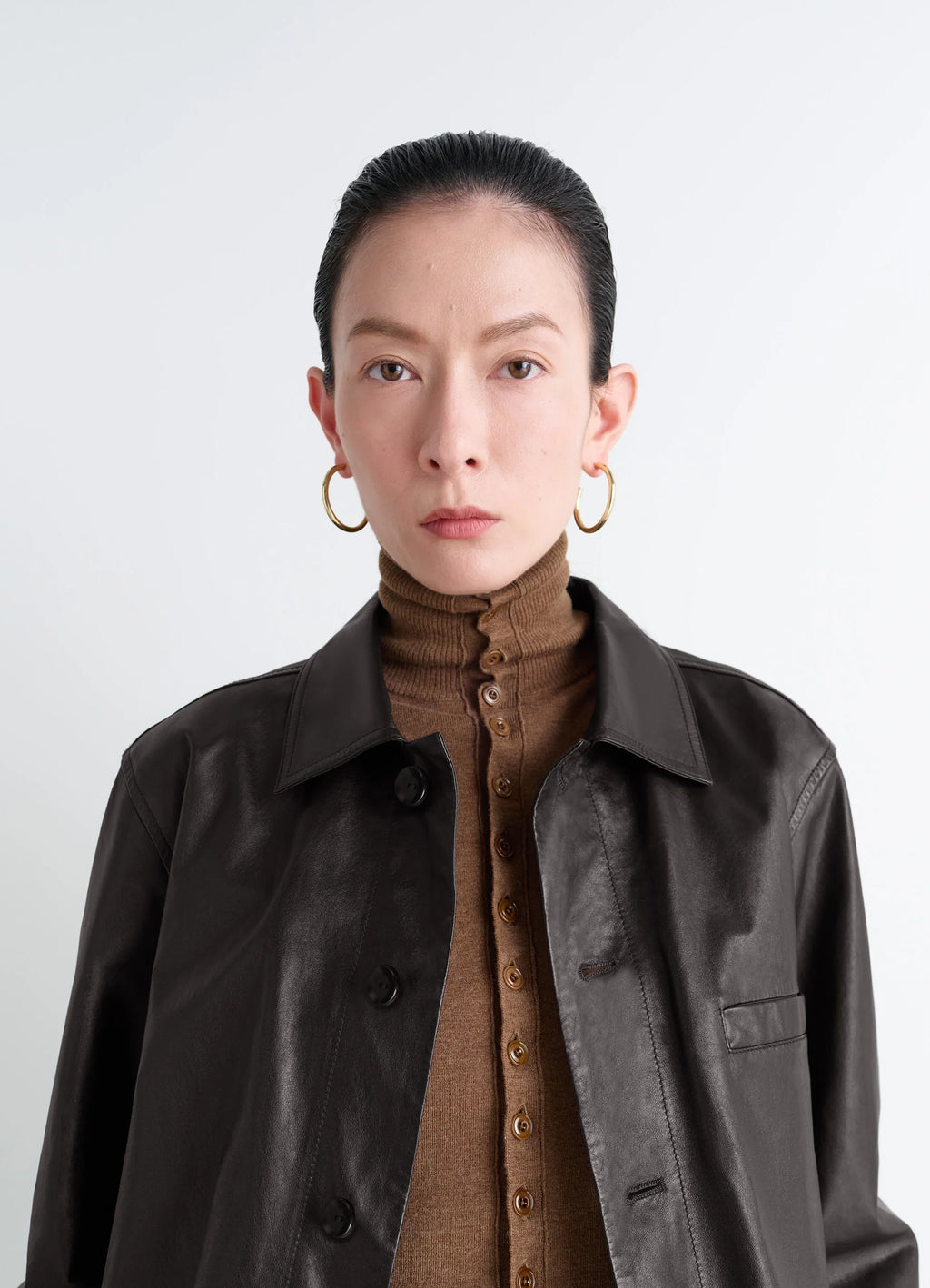 Classic hoops m in recycled gold-plated silver, model shot, side portrait worn with leather jacket