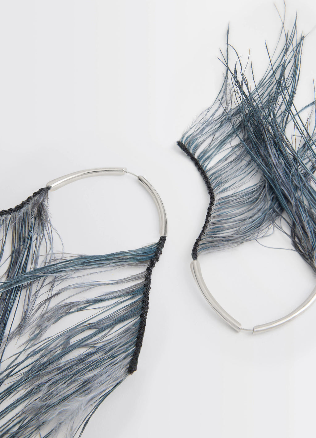 Feather earrings in dyed ostrich feathers, product shot, detail shot textured feather strands