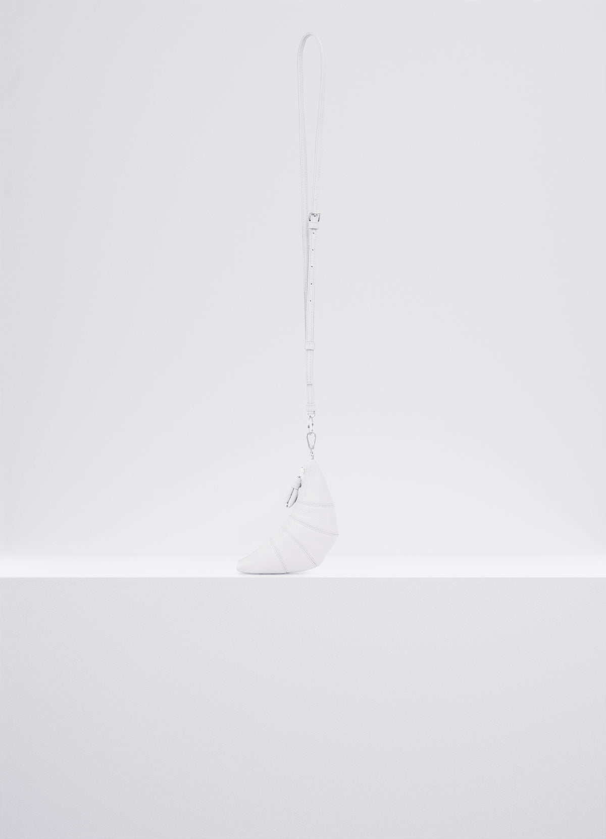 CROSS-BODY CROISSANT COIN PURSE in Soft grained leather, product shot, Side view Topstitched cutouts