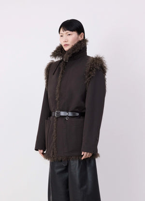 Lemaire reversible belted long shea in dark shearling and cotton twill, model shot, side view straight fit with belt