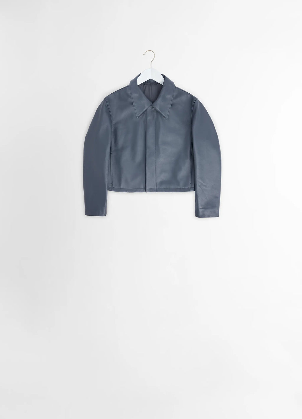 Boxy cropped jacket in heavy cow leather, product shot, hanging view minimalist design