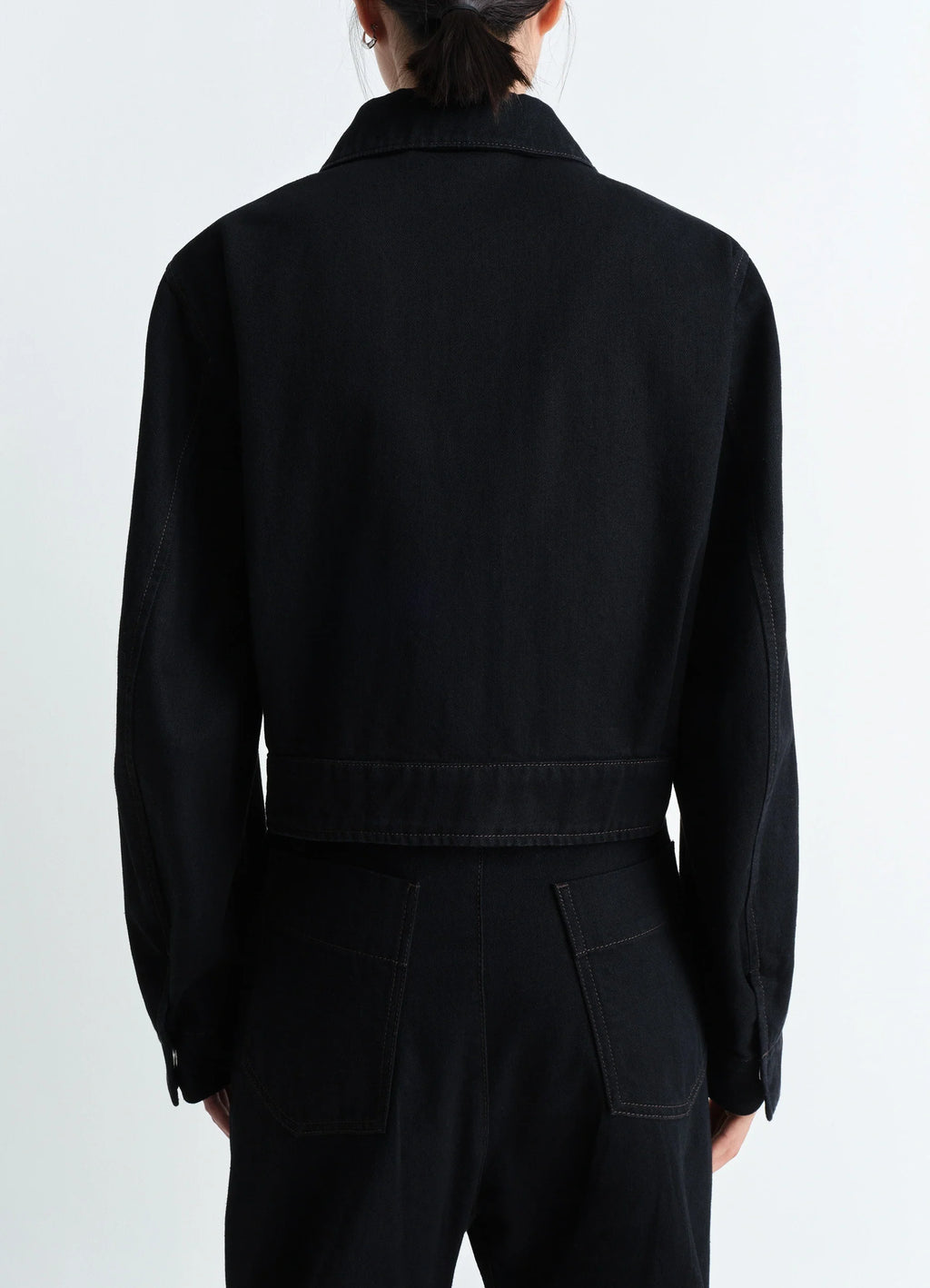Lemaire two pocket cropped jacket in deep black heavy denim, model shot, back view buttoned cuffs straight back