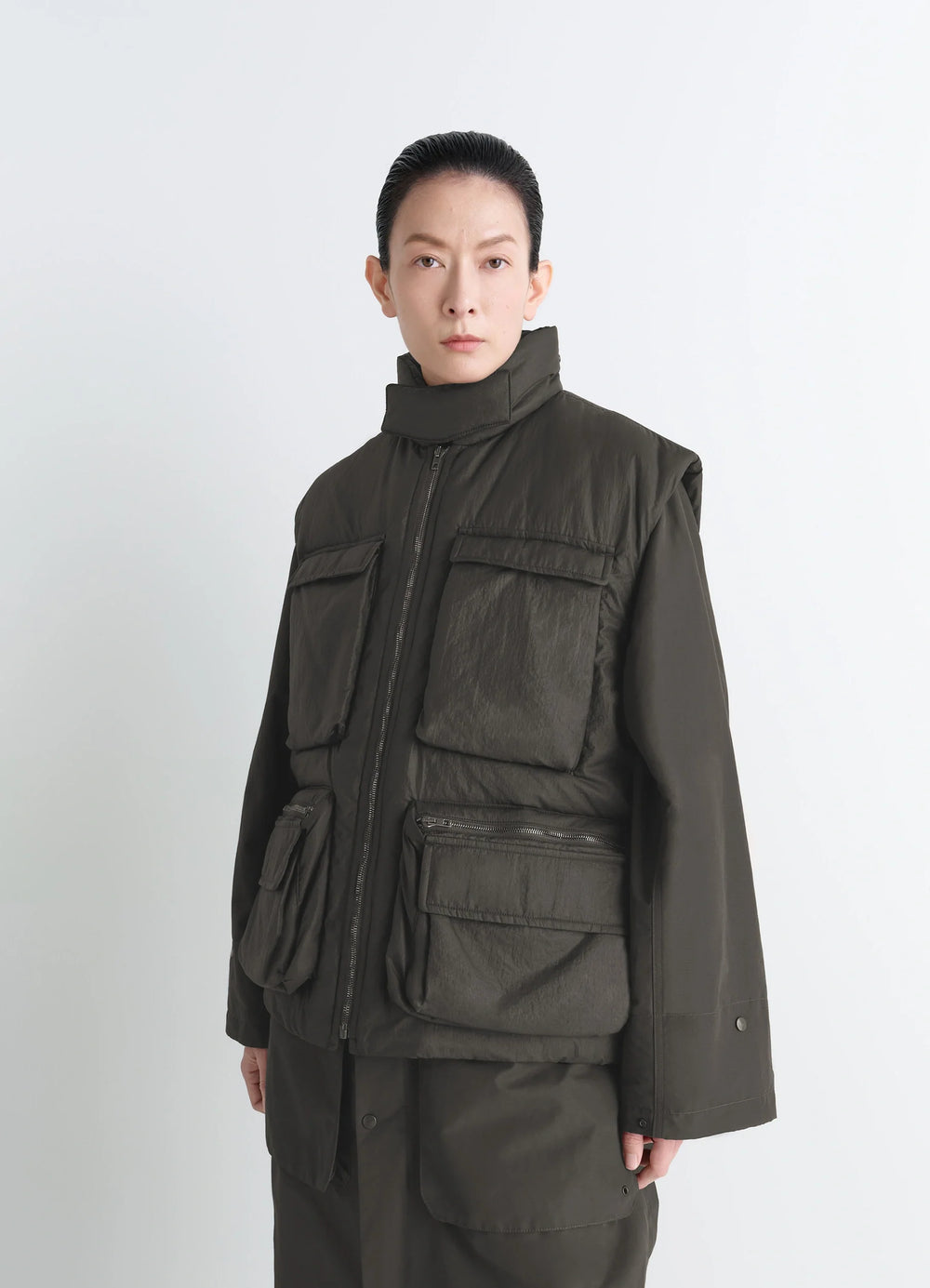 Lemaire Wadded Gilet in Deep Brown Nylon, model shot, Front side view Gusseted pockets