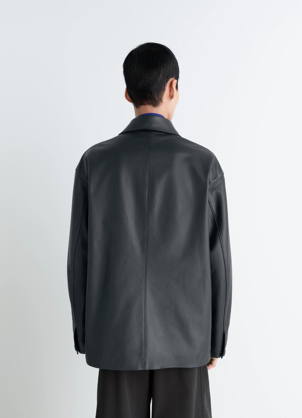 Lemaire leather workwear jacket in thick cow leather, grained, model shot, back view dropped shoulders