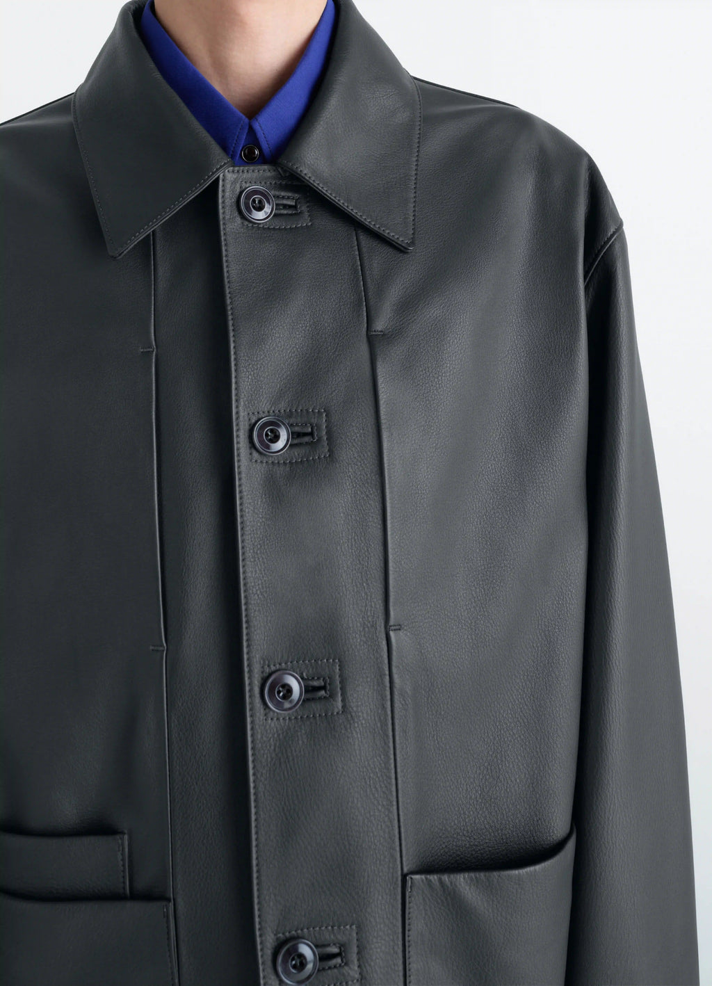 Lemaire leather workwear jacket in thick cow leather, grained, model shot, close-up view collared neckline, detailed buttons